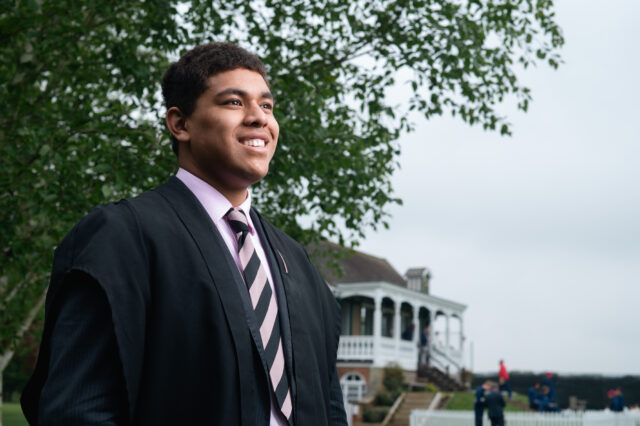 photo of Mosese smiling with the Radley Cricket Pavilion in the background