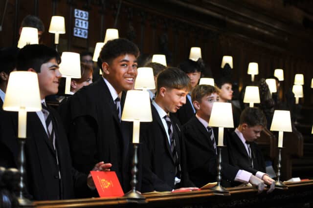 photo of Mosese smiling in Chapel surrounded by other Radley pupils